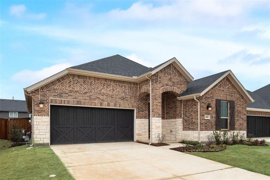 Front exterior of a new home in Spiritas Ranch, Little Elm, TX, highlighting curb appeal (Image 17).