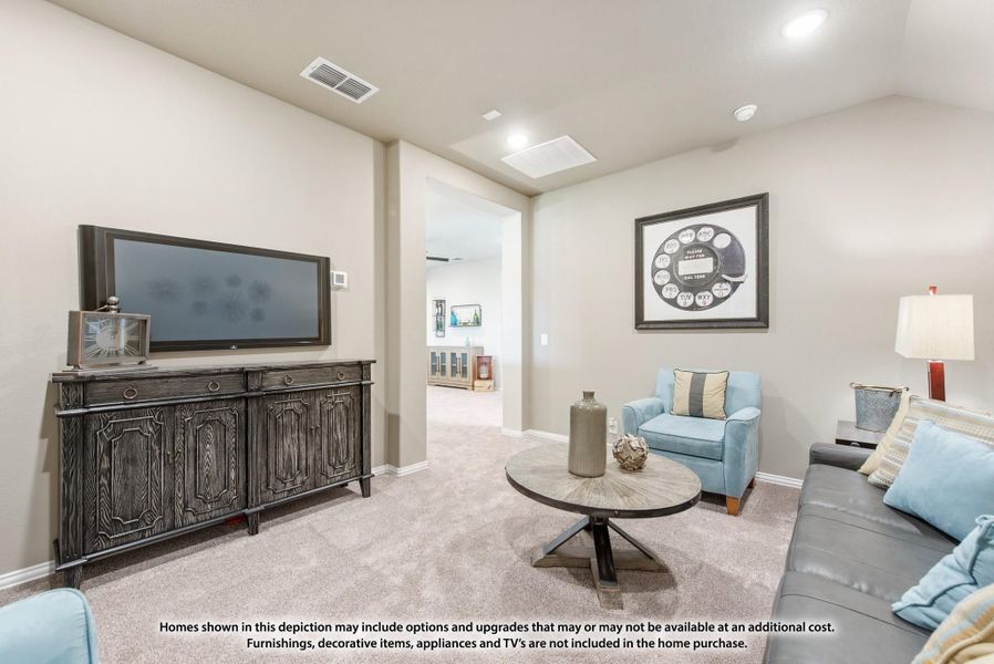 Living room with carpet, wall-mounted TV, dark wood media console, round coffee table, and blue accent chair. Living room with carpet, wall-mounted TV, dark wood media console, round coffee table, and blue accent chair.