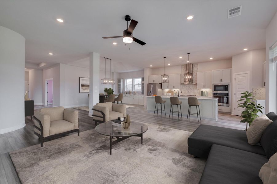 Open-concept living space featuring wood-finish flooring, recessed lighting, and a contemporary ceiling fan
