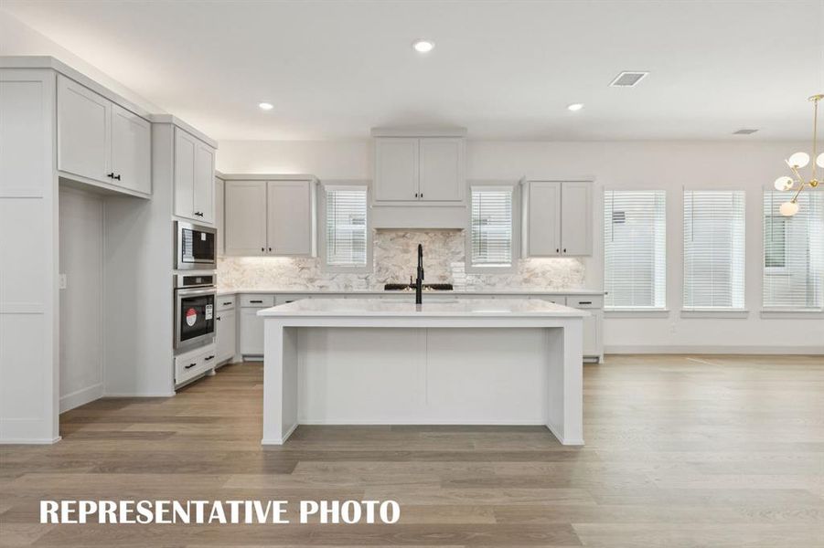 Your spacious kitchen island is the perfect place for friends and family to gather round.  REPRESENTATIVE PHOTO