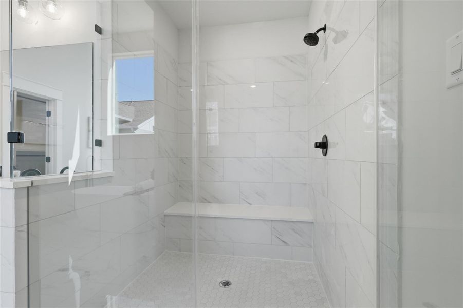 The primary bath offers a luxurious retreat with its sleek, modern tile design, spacious glass-enclosed shower, and elegant fixtures, perfect for unwinding in style. The primary bath offers a luxurious retreat with its sleek, modern tile design, spacious glass-enclosed shower, and elegant fixtures, perfect for unwinding in style.