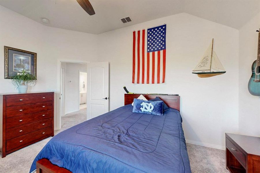 Bedroom featuring light carpet and a ceiling fan