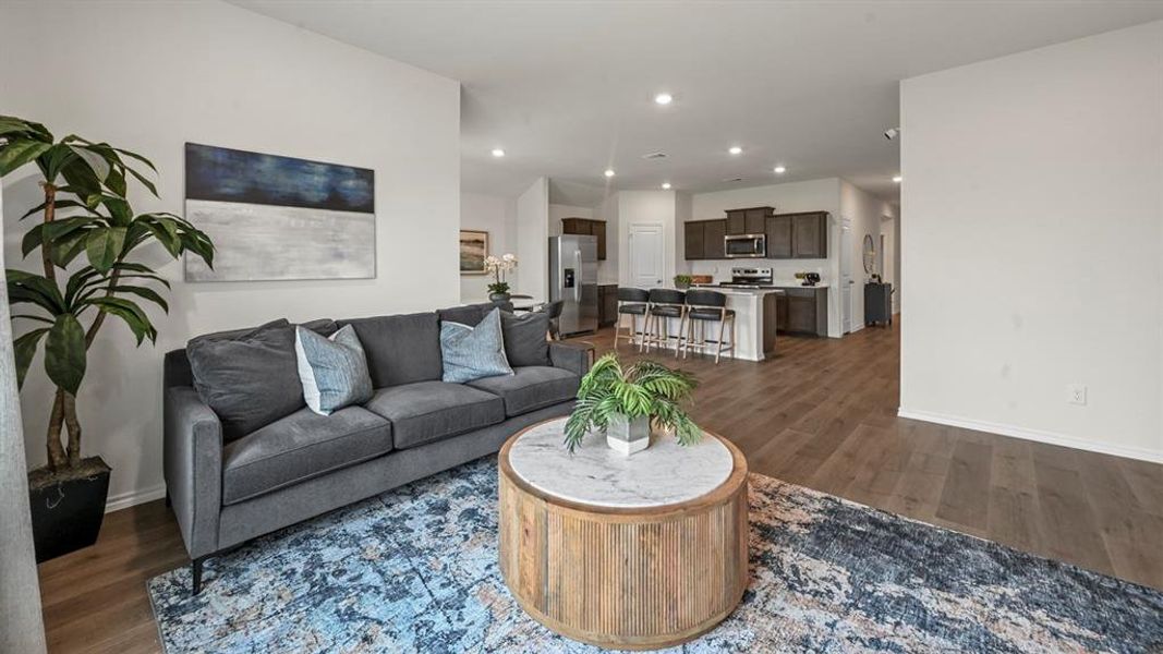 Living room with dark wood-type flooring and recessed lighting Living room with dark wood-type flooring and recessed lighting