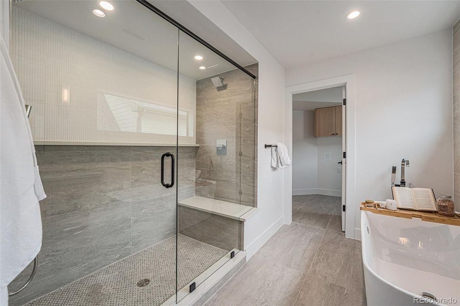 Large walk-in shower with dual showerheads & deep soaking tub