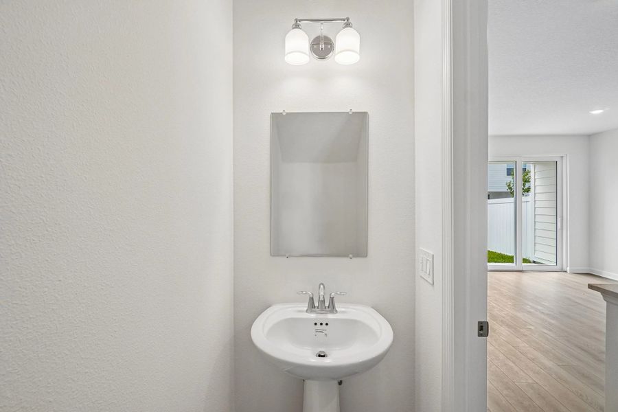 Half bathroom located off the kitchen on the first floor