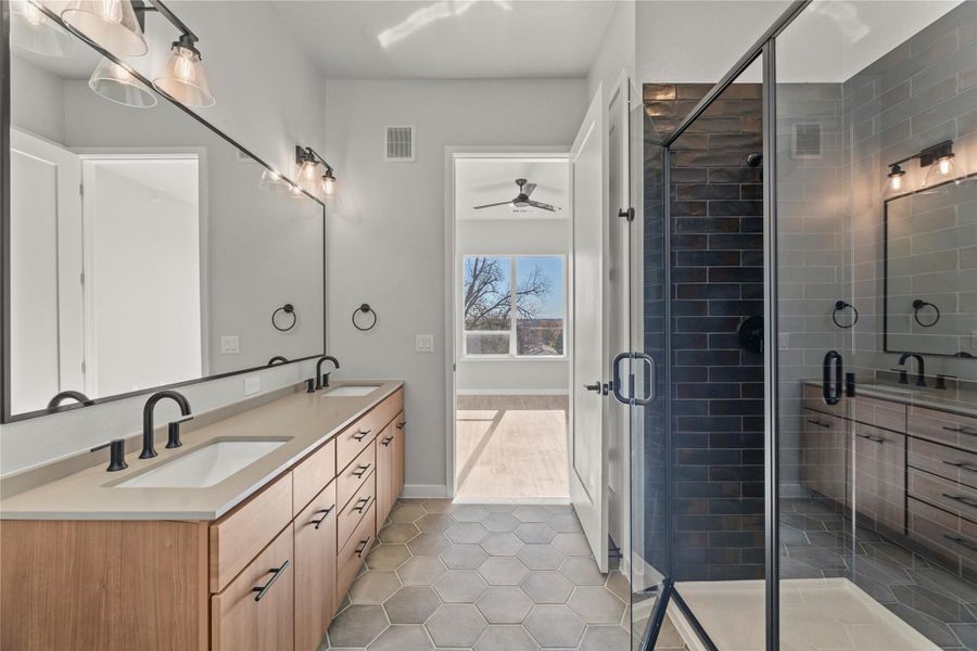 Bathroom featuring vanity, tile patterned floors, ceiling fan, and walk in shower