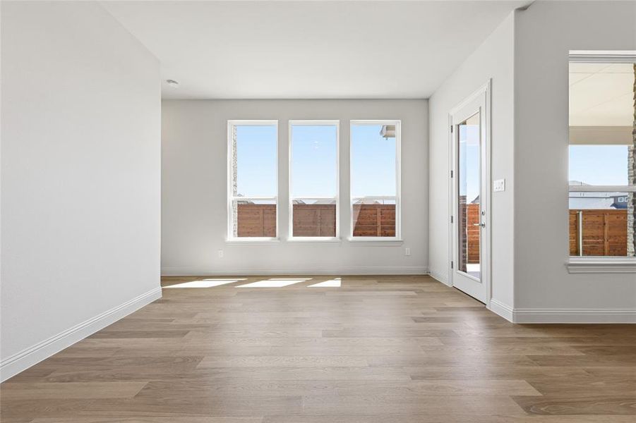 Empty room featuring light wood finished floors and baseboards