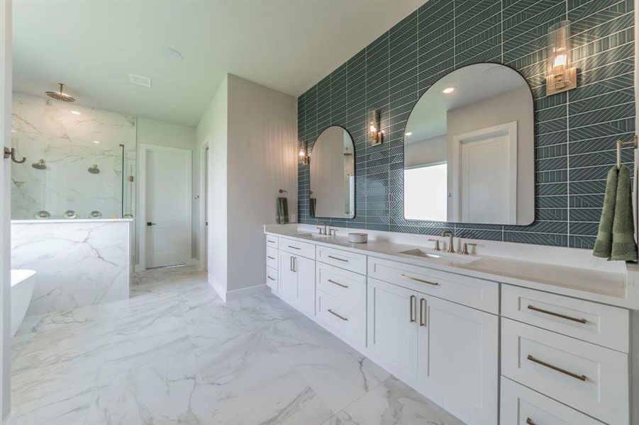 Full bathroom with tile walls, a marble finish shower, double vanity, a freestanding tub, and marble finish floors Full bathroom with tile walls, a marble finish shower, double vanity, a freestanding tub, and marble finish floors