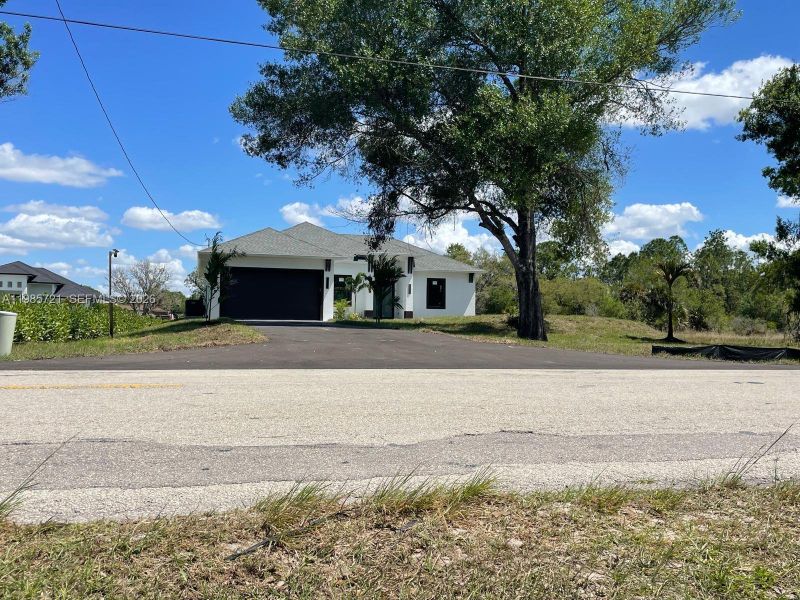 Front exterior of a new home in , Naples, FL, highlighting curb appeal (Image 2). Front exterior of a new home in , Naples, FL, highlighting curb appeal (Image 2).