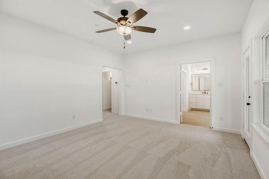 Spacious room featuring light-toned carpet, recessed lighting, and a ceiling fan with integrated lighting