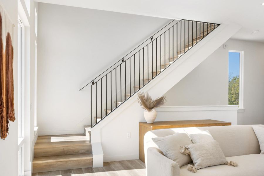 Stairway featuring wood finished floors and baseboards