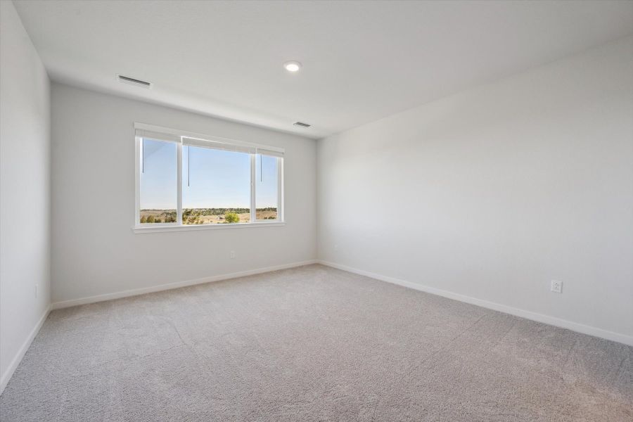 A room with a window and a carpet. A room with a window and a carpet.