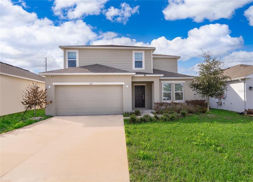 Front exterior of a new home in Marion Creek, Haines City, FL, highlighting curb appeal (Image 1). Front exterior of a new home in Marion Creek, Haines City, FL, highlighting curb appeal (Image 1).