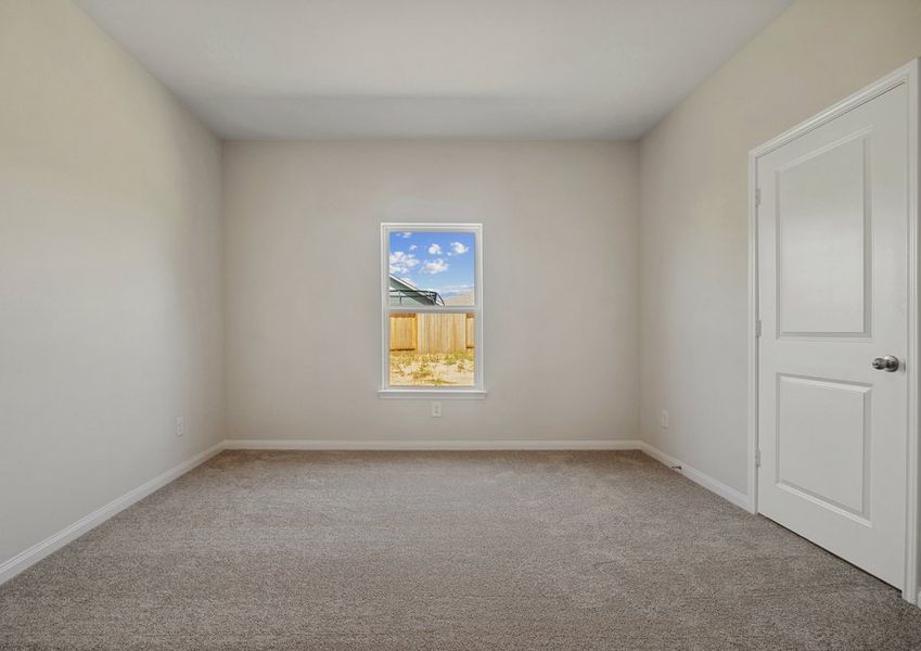 Master bedroom with a window overlooking the backyard Master bedroom with a window overlooking the backyard