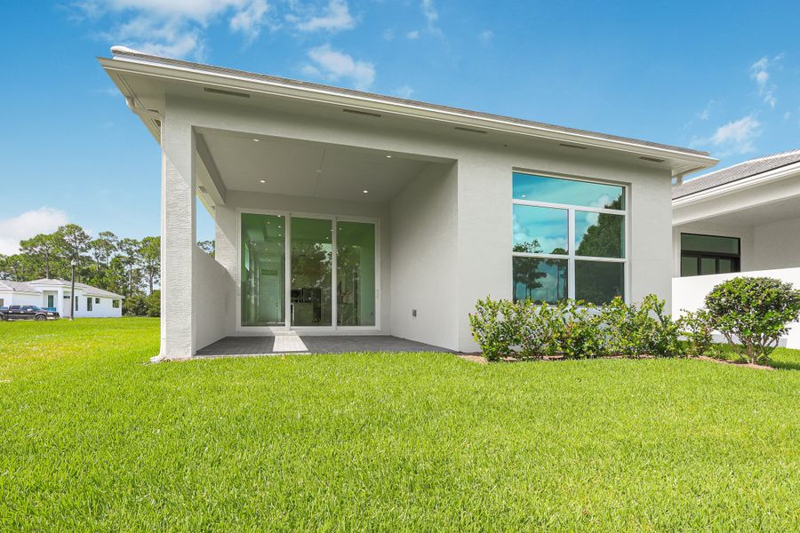 Front exterior of a new home in Rivella, Port St. Lucie, FL, highlighting curb appeal (Image 18).