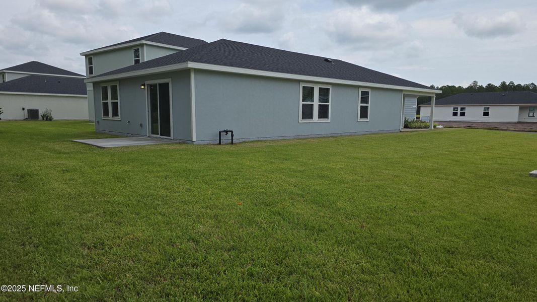 Front exterior of a new home in Flagler Village - Classic Series, Palm Coast, FL, highlighting curb appeal (Image 27). Front exterior of a new home in Flagler Village - Classic Series, Palm Coast, FL, highlighting curb appeal (Image 27).
