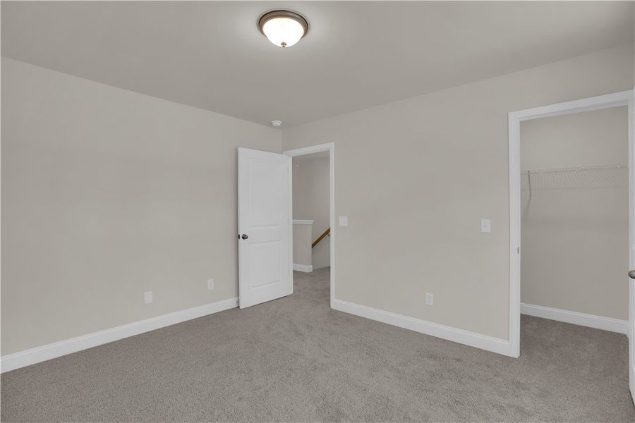 This spacious bedroom offers comfortable carpeting This spacious bedroom offers comfortable carpeting