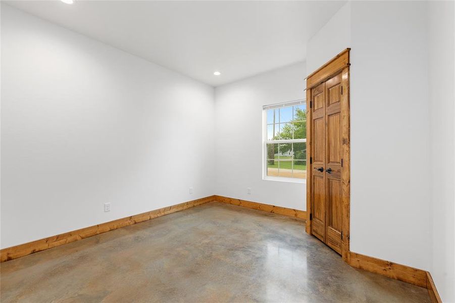 Room featuring finished concrete floors, baseboards, and recessed lighting Room featuring finished concrete floors, baseboards, and recessed lighting
