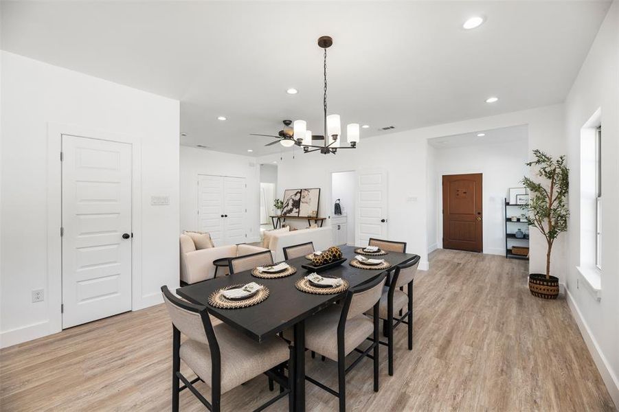 Dining room with light wood finished floors, a chandelier, and recessed lighting Dining room with light wood finished floors, a chandelier, and recessed lighting