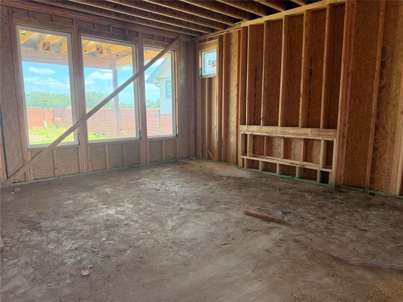 Framed-out interior space awaits customization with windows inviting natural light.