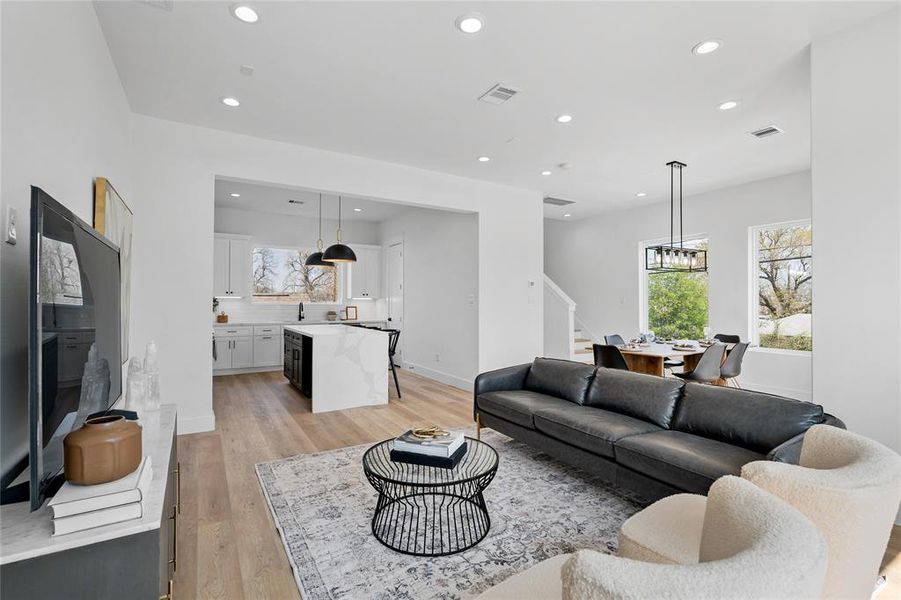 Picture-perfect living space on the second floor, boasting an open concept layout flooded with natural light from variously sized windows, offering an added cost but unparalleled value in ambiance and style.