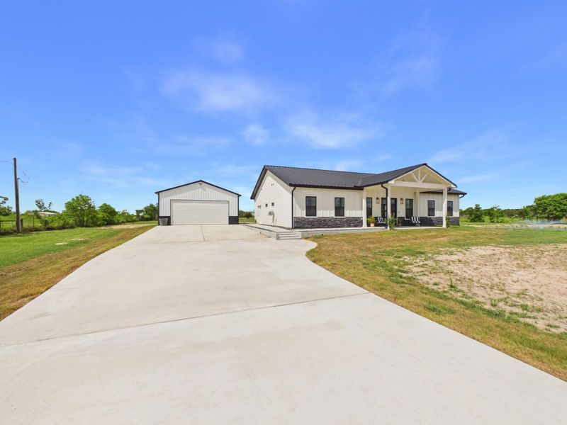 Front exterior of a new home in , Sealy, TX, highlighting curb appeal (Image 20).