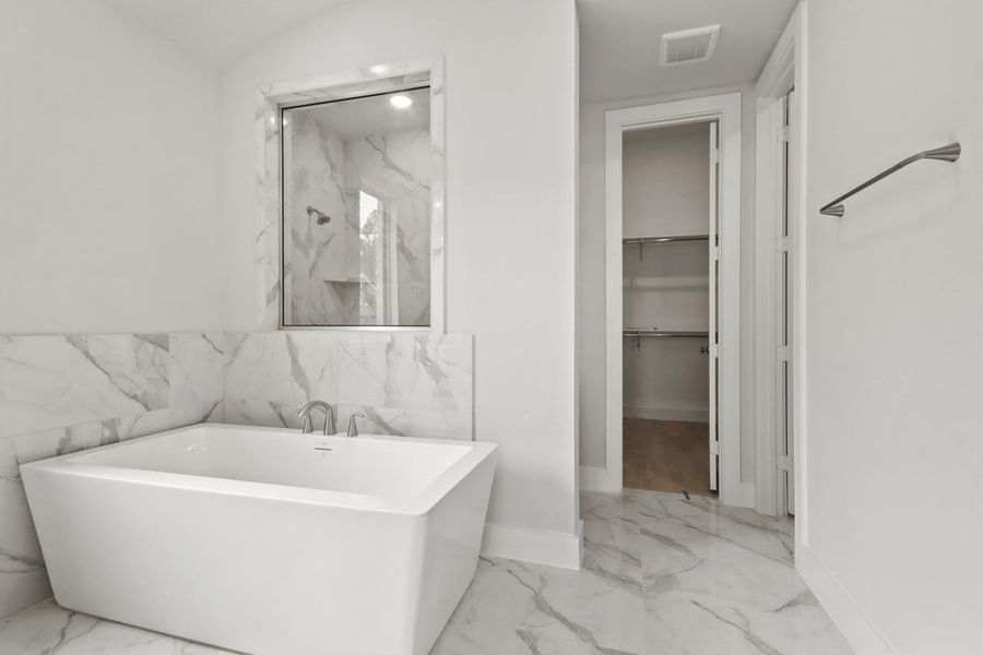 Full bath featuring a marble finish shower, marble finish floor, visible vents, and a freestanding tub Full bath featuring a marble finish shower, marble finish floor, visible vents, and a freestanding tub