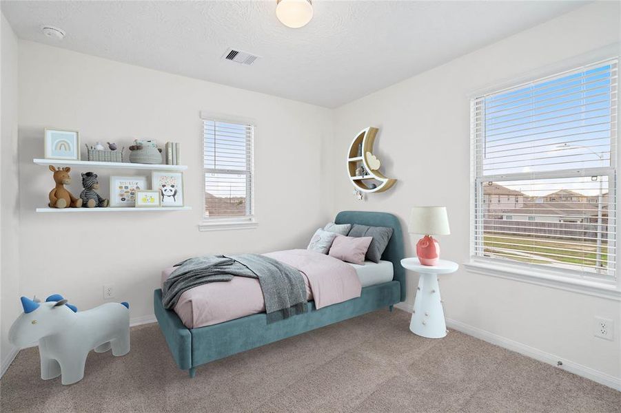 Secondary bedroom features plush carpet, neutral paint, lighting, windows with privacy blinds and ample sized closet space.