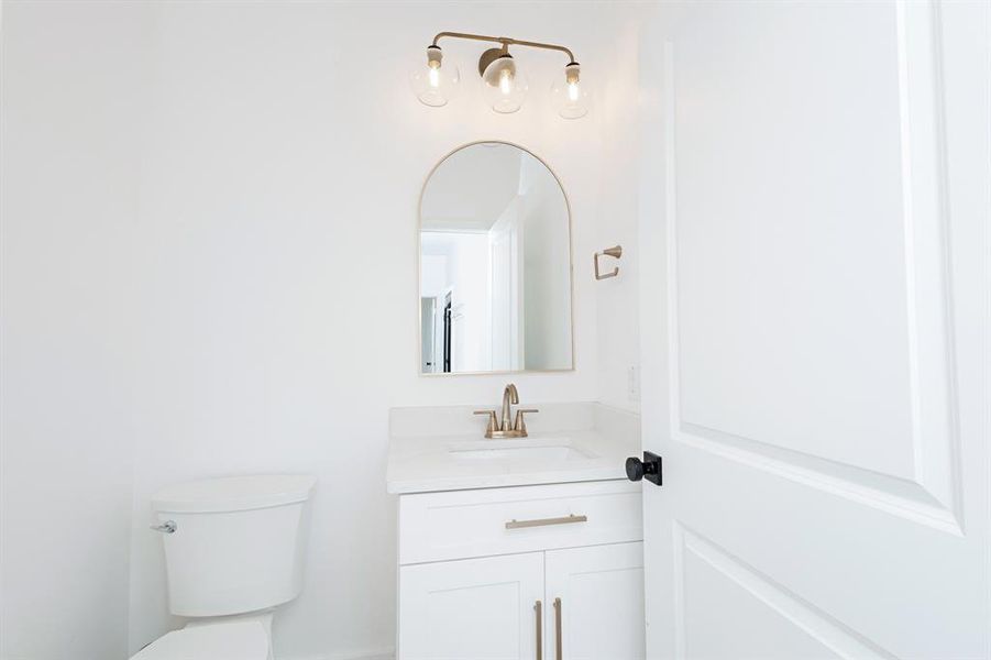 Half bath with vanity and toilet