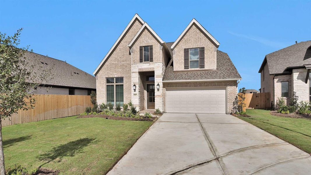 Front exterior of a new home in Stonecreek Estates 50', Richmond, TX, highlighting curb appeal (Image 1).