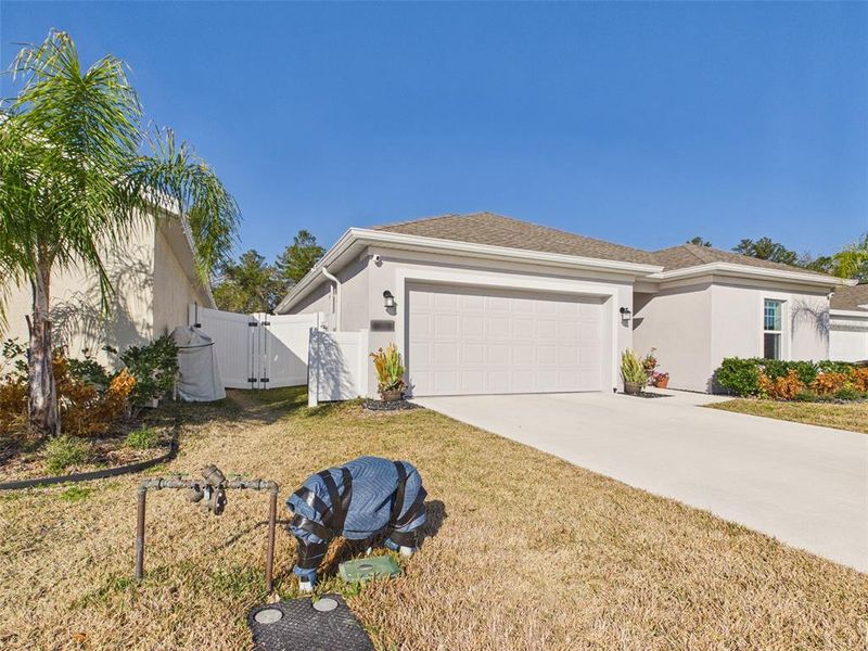 Front exterior of a new home in Vineland Reserve, Osteen, FL, highlighting curb appeal (Image 23).