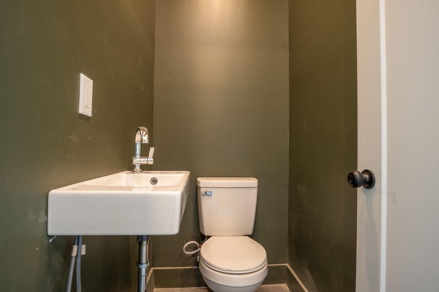 Half bathroom with toilet and a sink
