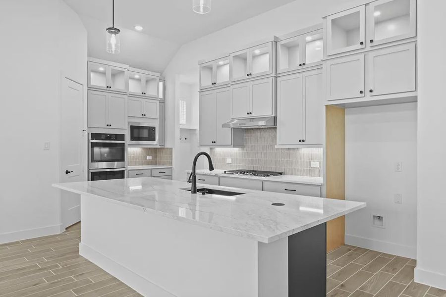 Representative furnished interior of a home built from the Summerton by Chesmar Homes in University Heights, Round Rock (Image 7).