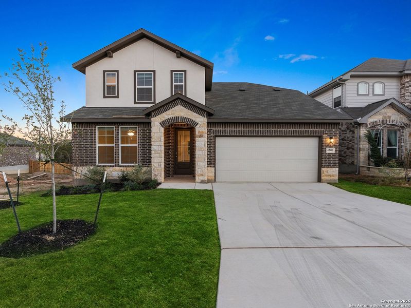 Front exterior of a new home in Comanche Ridge, San Antonio, TX, highlighting curb appeal (Image 1). Front exterior of a new home in Comanche Ridge, San Antonio, TX, highlighting curb appeal (Image 1).