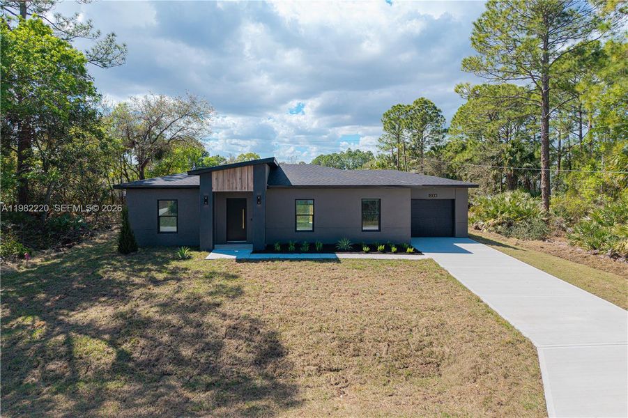Front exterior of a new home in , Palm Bay, FL, highlighting curb appeal (Image 27).