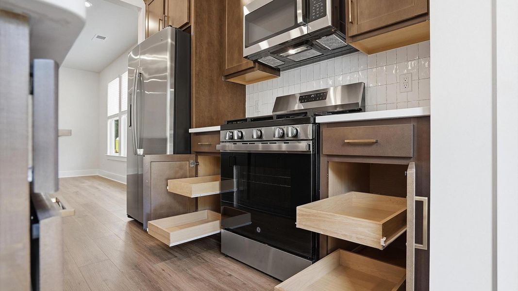 Exclusive DRB Homes kitchen with abundant storage, elevated finishes, and stainless appliances in a prime location Exclusive DRB Homes kitchen with abundant storage, elevated finishes, and stainless appliances in a prime location