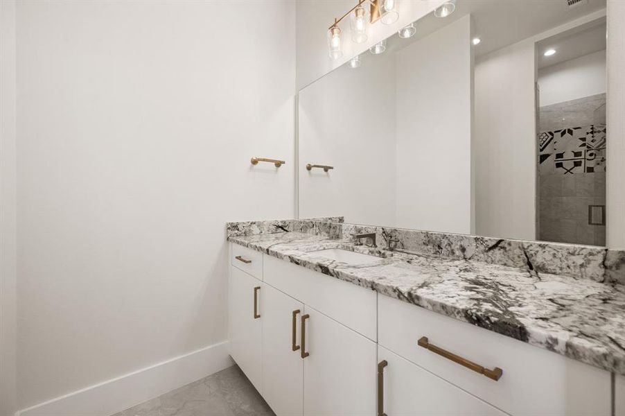 Bathroom featuring vanity and a shower with shower door