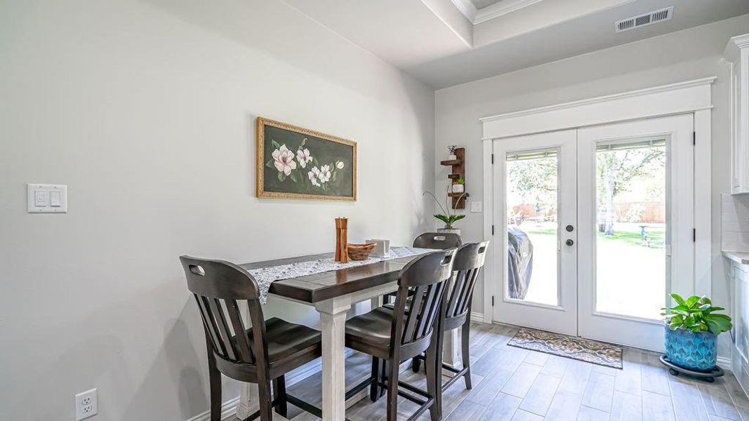 Dining area with french doors and hardwood / wood-style floors