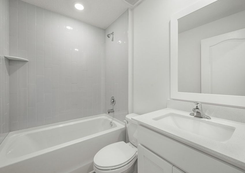 The guest bathroom has beautiful white tile detail. The guest bathroom has beautiful white tile detail.