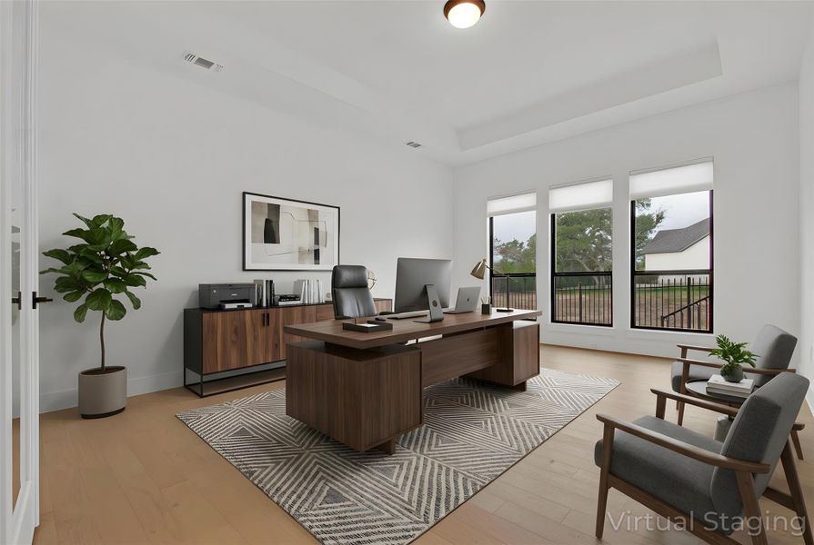 Virtually-Staged Flex Room with raised tray ceiling and light hardwood floors