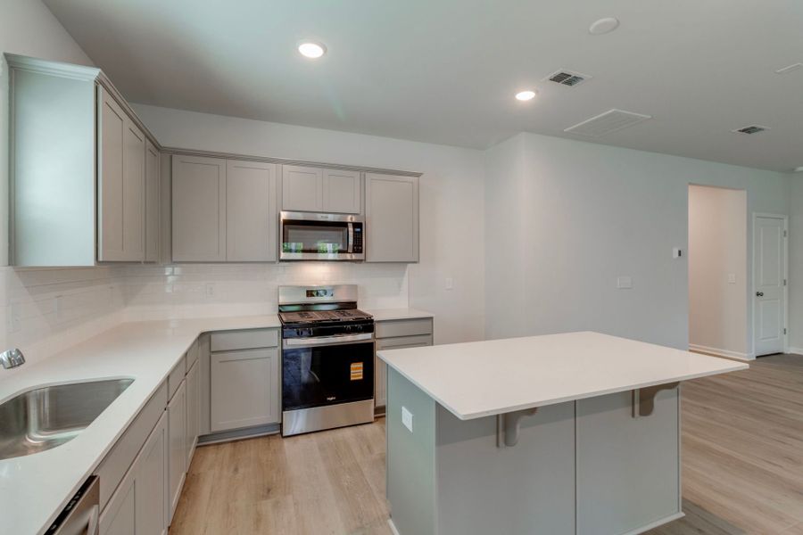Discover the modern elegance in the kitchen with sleek grey cabinets.