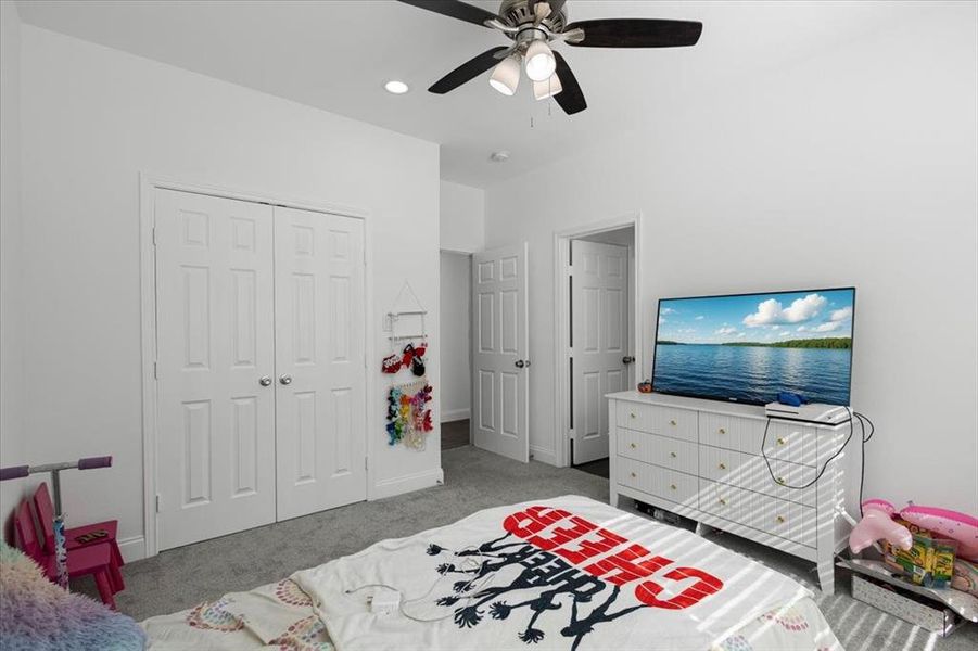 Bedroom featuring light colored carpet, a closet, ceiling fan, and recessed lighting Bedroom featuring light colored carpet, a closet, ceiling fan, and recessed lighting