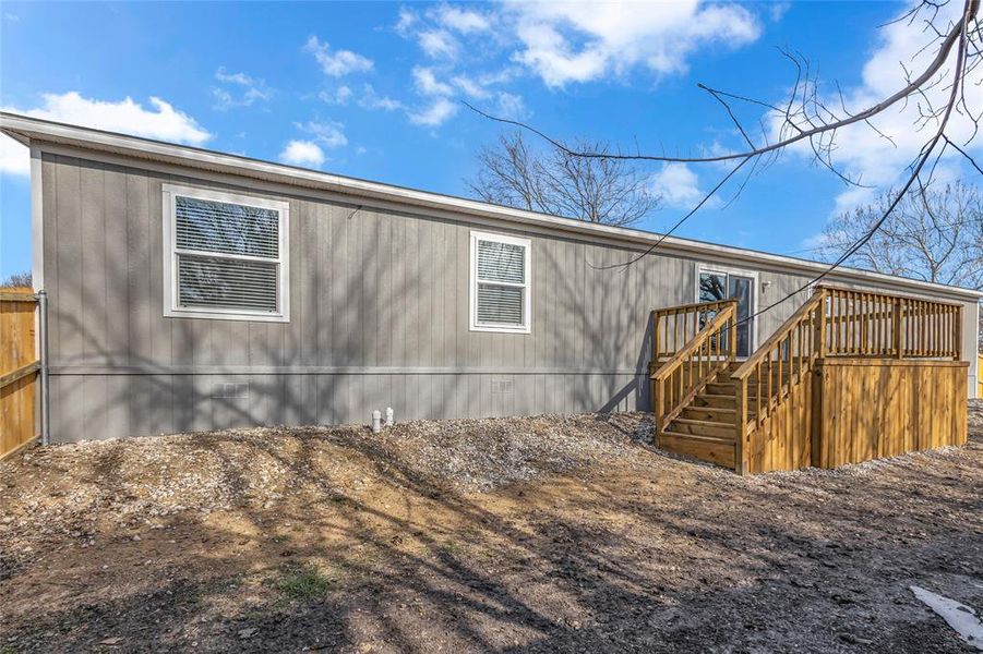 Rear view of house featuring a wooden deck