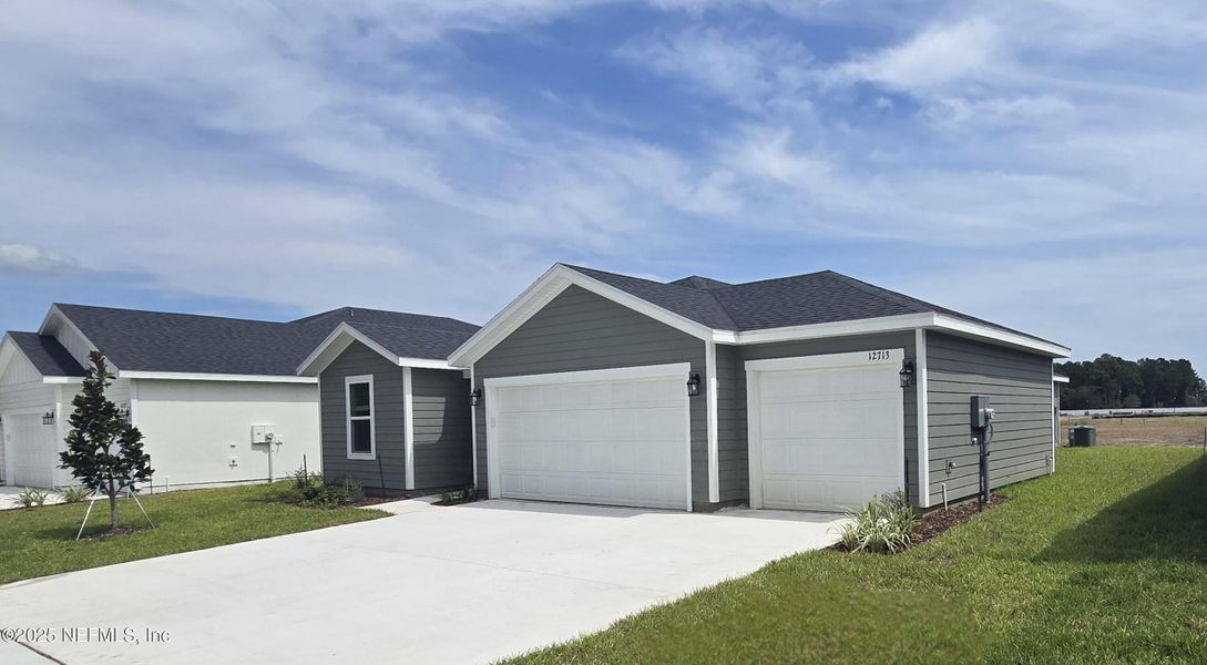 Front exterior of a new home in Azalea Creek, Jacksonville, FL, highlighting curb appeal (Image 1).