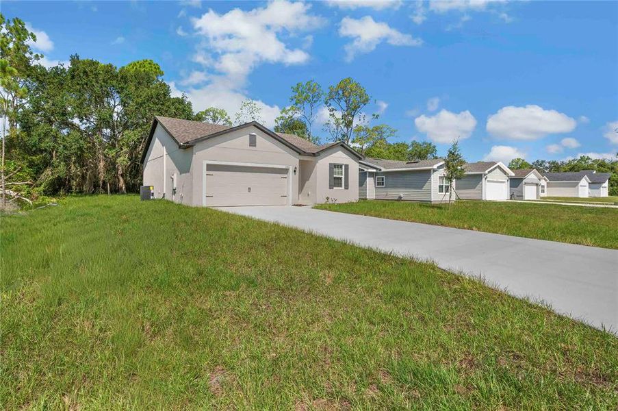 Front exterior of a new home in Poinciana, Poinciana, FL, highlighting curb appeal (Image 15).