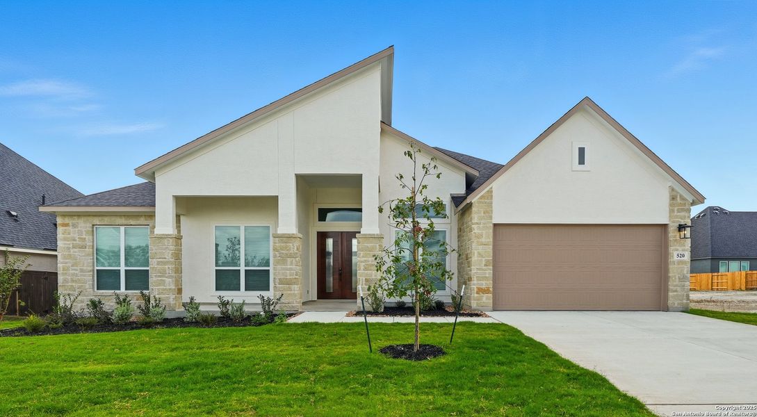 Front exterior of a new home in Mesa Western, Cibolo, TX, highlighting curb appeal (Image 2). Front exterior of a new home in Mesa Western, Cibolo, TX, highlighting curb appeal (Image 2).