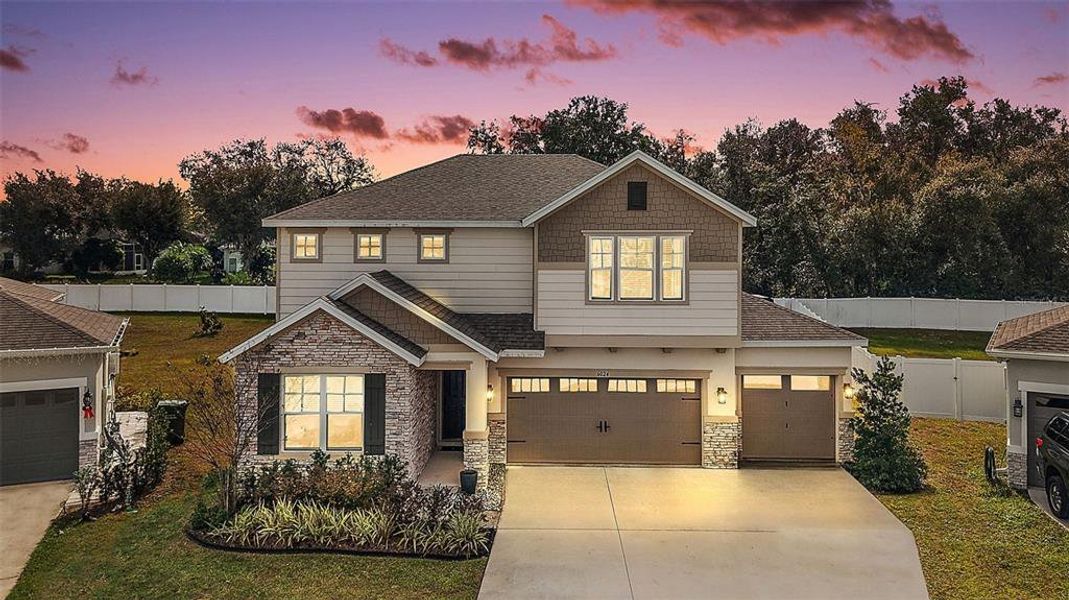 Front exterior of a new home in Seasons at Spring Creek, Okahumpka, FL, highlighting curb appeal (Image 2). Front exterior of a new home in Seasons at Spring Creek, Okahumpka, FL, highlighting curb appeal (Image 2).