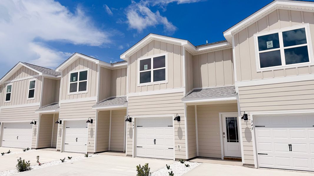 Front exterior of a new home in WindMark Beach, Port Saint Joe, FL, highlighting curb appeal (Image 19).