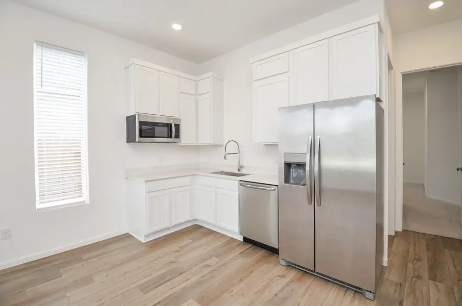 Fully equipped kitchen in the guest quarters opens the living space, just behind it the laundry room, bedroom and full bath