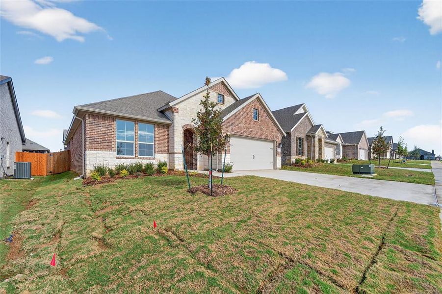 Front exterior of a new home in Liberty Pointe, Gainesville, TX, highlighting curb appeal (Image 2).